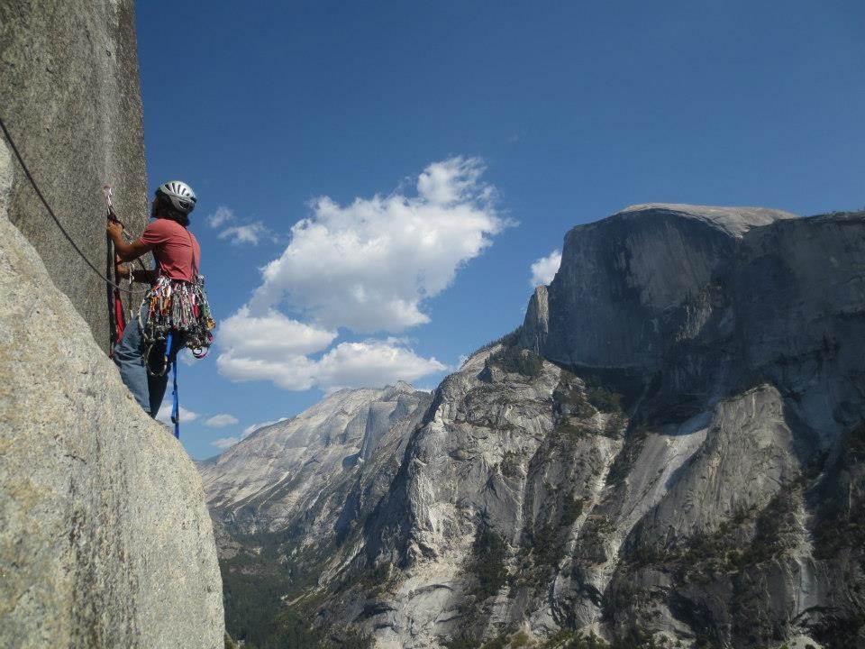 Hamik aiding an upper pitch of The Prow on Washington Column with Half Dome visible in the background.